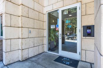 A door to a building with a sign on the side of it