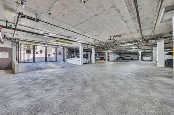 An empty parking garage with cars parked in it