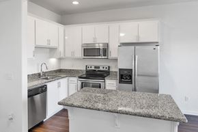 San Jose apartment for rent - a kitchen with granite counter tops and stainless steel appliances at Aviara Apartments, San Jose