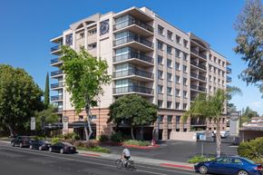 Palo Alto apartment for rent - Apartments in Palo Alto, California - Tan Plaza - Exterior View of Tan Plaza Building with Trees, View of Covered Parking, Street View, and Unit Balconies