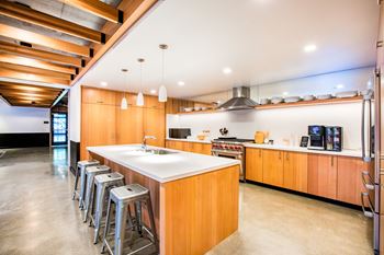 A modern kitchen with wooden cabinets and a large island.