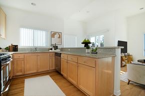 Los Angeles apartment for rent - A kitchen with wooden cabinets and a granite countertop.at Grand View Towers, Los Angeles  