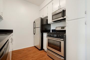 Los Angeles apartment for rent - A kitchen with a black refrigerator, stove, and oven.