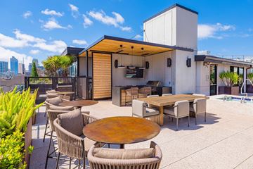 San Francisco apartment for rent - A modern outdoor dining area with a wooden table surrounded by chairs.
