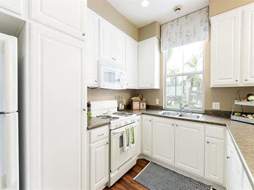 Ventura apartment for rent - A kitchen with white cabinets and appliances.