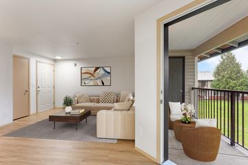Vancouver apartment for rent - A living room with a brown couch, a coffee table, and a painting on the wall.