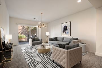 Novato apartment for rent - A living room with a grey sofa and a coffee table.