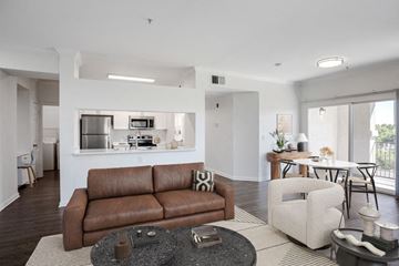 Sacramento apartment for rent - A brown leather couch sits in a living room with a coffee table in front of it.