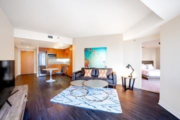 San Francisco apartment for rent - A living room with a couch, a table, and a painting on the wall.