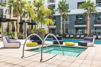 A pool area with a blue and yellow pool chair.