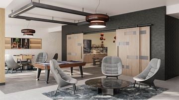 Monrovia apartment for rent - A modern living room with a grey chair and a black and white rug.