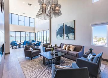 Chula Vista apartment for rent - A modern living room with a large window and a painting on the wall.