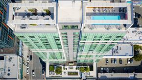 Oakland apartment for rent - A modern building with a glass facade and a pool on the top floor.