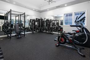 Murrieta apartment for rent - A spacious gym with a variety of equipment including treadmills, weights, and exercise machines. at Sonoma at Mapleton Apartments, West Murrieta, CA 92563