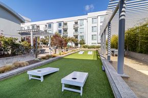 San Francisco apartment for rent - Outdoor Recreation Area with Artificial Turf, Corn Hole Boards, Landscaped Plants, Gravel, Seating Area  at Strata at Mission Bay, San Francisco