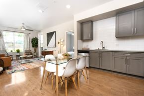 Redlands apartment for rent - A modern kitchen with a dining table and chairs.