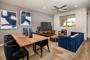 San Pedro townhouse for rent - A modern living room with a wooden table and black chairs.