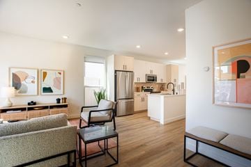 Sacramento apartment for rent - a living room with furniture and a kitchen in the background