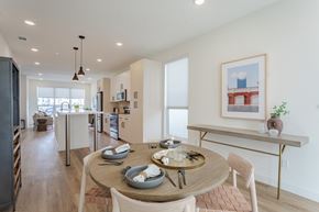 Sacramento apartment for rent - A modern dining room with a wooden table set for two.