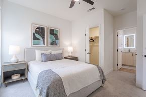 Sacramento apartment for rent - A bedroom with a large bed and a ceiling fan.