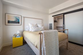 Berkeley apartment for rent - Luxury Three-Bedroom Apartments in Berkeley, CA - The Addison - Bedroom with Carpeted Flooring, Bed, Nightstand with Lamp, Framed Wall Art, and Spacious Closet.