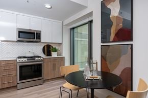 Oakland apartment for rent - A modern kitchen with a black table and chairs.
