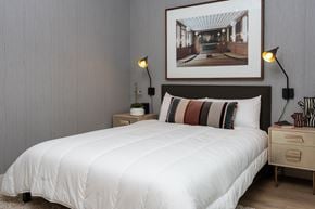 Oakland apartment for rent - A bedroom with a white bed and a picture on the wall.
