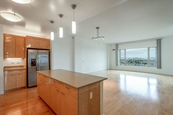 A kitchen with wooden cabinets and a large island.
