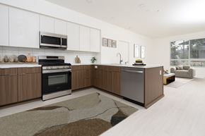 Monrovia apartment for rent - A modern kitchen with wooden cabinets and a black and white oven. at Trestle, California