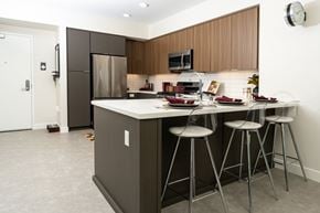Monrovia apartment for rent - A kitchen with a white counter top and a white fridge.