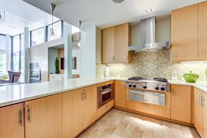 San Francisco apartment for rent - Apartments Kitchen With Wooden Cabinetry And Multi-Colored Tile Backsplash at Venue, San Francisco, CA