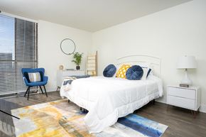 San Diego apartment for rent - Bedroom with white nightstand and light, large windows at Vera Cortez Hill, San Diego, CA, 92101
