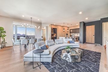 Las Vegas apartment for rent - A modern living room with a curved sofa and a coffee table in the center.