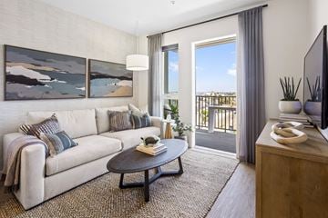 San Pedro apartment for rent - A living room with a white couch, a coffee table, and a painting on the wall.