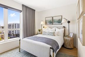 San Pedro apartment for rent - A bedroom with a large bed and a view of the city.