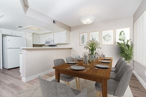Thousand Oaks apartment for rent - Dining Area with Table and Chairs and Kitchen in Background with Breakfast Bar and White Cabinetry at Westlake Canyon, California