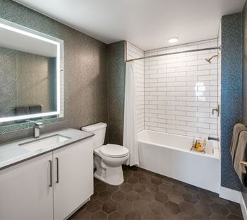 Spa inspired baths with ceramic-tile shower surrounds and porcelain tile flooring