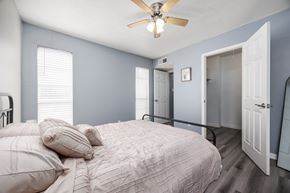 El Paso apartment for rent - A bedroom with a bed, pillows, and a ceiling fan.