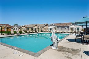 Roseville townhouse for rent - A pool with a diving board and a fountain in the middle of it.