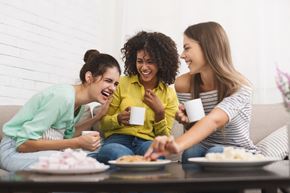 Upland apartment for rent - a group of women sitting on a couch eating food and drinking coffee