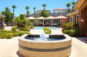 Henderson apartment for rent - A fountain in the middle of a pool surrounded by a brick wall at Avalon at Seven Hills Apartments, Henderson, 91790