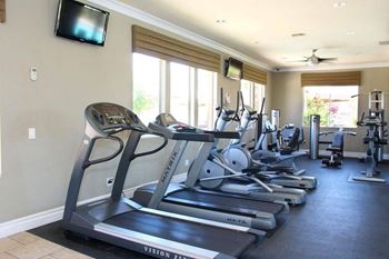 A gym with treadmills and exercise equipment.