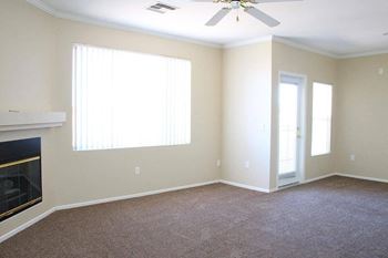 A room with a fireplace and a ceiling fan.