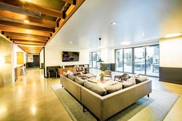 San Francisco apartment for rent - A modern living room with a large sectional sofa and a wooden ceiling.