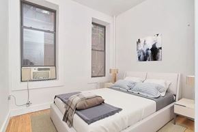 New York apartment for rent - A bedroom with a large bed and a painting on the wall.