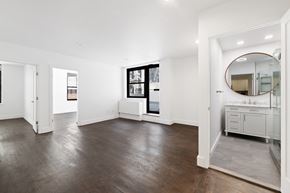 New York apartment for rent - A spacious room with wooden floors and white walls.