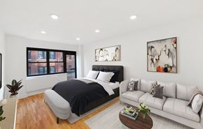 New York apartment for rent - A modern bedroom with a large bed and a couch.