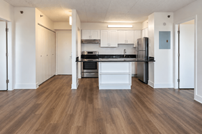 New Britain apartment for rent - A kitchen with white cabinets and a black fridge.