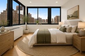 New York apartment for rent - A bedroom with a large bed and a view of the city.