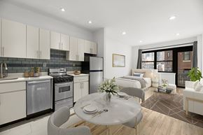 New York apartment for rent - A modern kitchen with a dining table set for two.